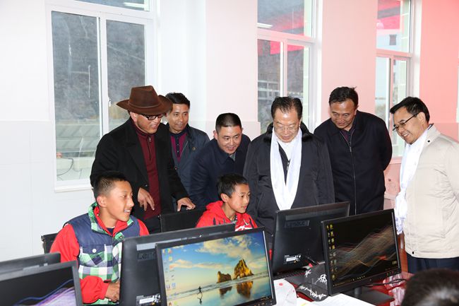 10、張學(xué)武董事長一行在集團捐助的德欽縣“希望之星”電腦室考察，并饒有興致地教授學(xué)生使用搜索引擎_副本.jpg